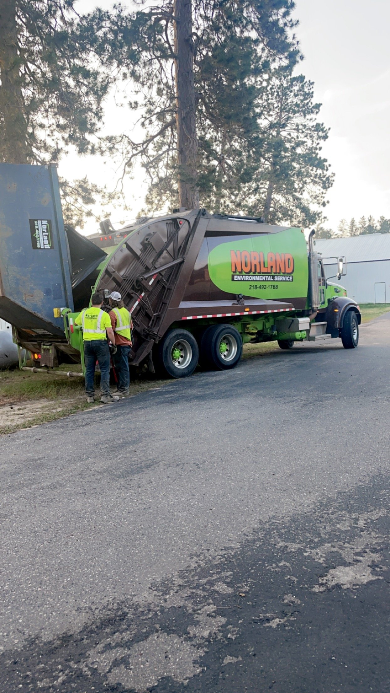 Walter's crew servicing a commercial dumpster